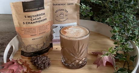 Image features a tray holding a cup of Chai Spiced 5 Mushroom Cacao next to a bag of Harmonic Arts Chai Spice Artisan Tea and a bag of Harmonic Arts 5 Mushroom Cacao Herbal Latte.